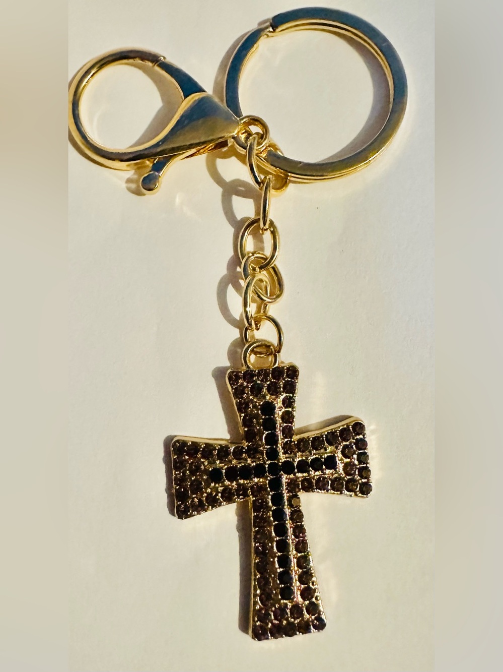 Gold Tone Cross Keychain with Dark Purple Crystal Accents